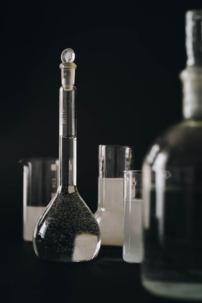 Close-up of laboratory glassware with chemical solutions for scientific research and analysis.